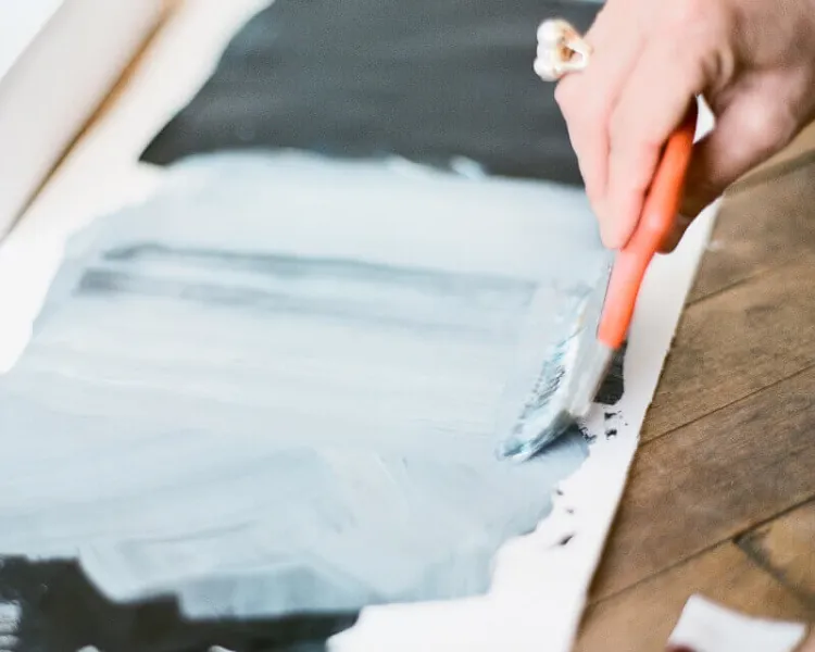 Designer painting brand artwork